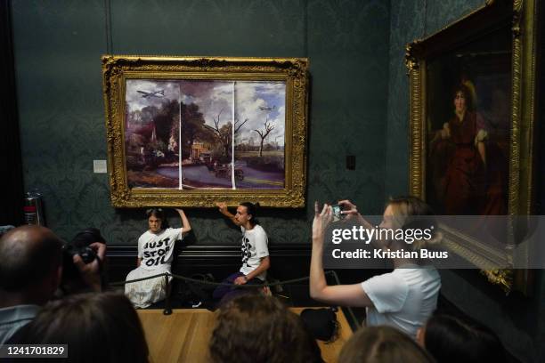 Just Stop Oil climate activists subvert The Hay Wain painting by John Constable and glue themselves to the frame at the National Gallery on the 4th...