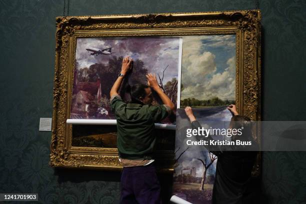 Just Stop Oil climate activists subvert The Hay Wain painting by John Constable and glue themselves to the frame at the National Gallery on the 4th...