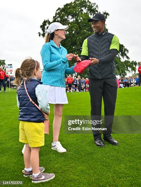 Limerick , Ireland - 4 July 2022; Tiger Woods of USA signs an autograph for Ella Doe, daughter of Shelly McManus, during day one of the JP McManus...