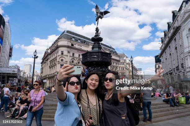 Tourists take a selfie at Piccadilly Circus on 28th June 2022 in London, United Kingdom. London is one of the worlds leading tourism destinations,...