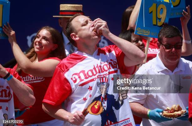 Joey Chestnut eats hot dogs during the 2022 Nathans Famous Fourth of July International Hot Dog Eating Contest on July 4, 2022 at Coney Island in the...