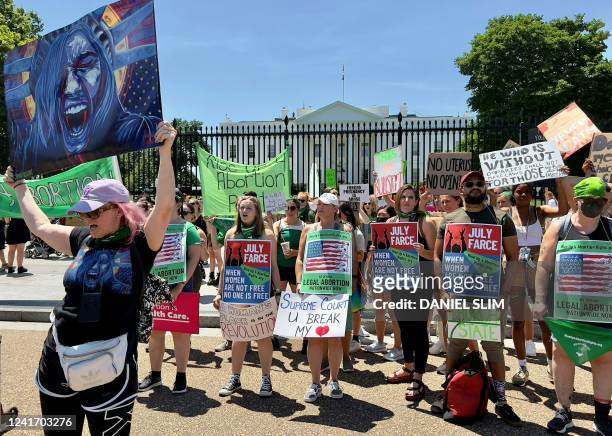 Group of abortion rights activists hold up signs outside the White House in Washington, DC on July 4, 2022. - Abortion has become unavailable or...