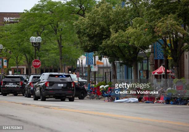 First responders work the scene of a shooting at a Fourth of July parade on July 4, 2022 in Highland Park, Illinois. Reports indicate at least six...