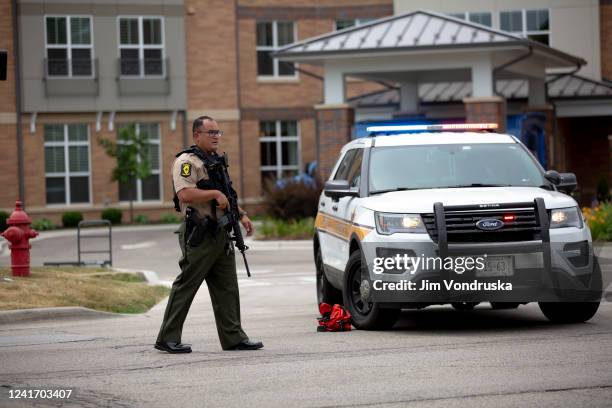 First responders work the scene of a shooting at a Fourth of July parade on July 4, 2022 in Highland Park, Illinois. Reports indicate at least five...