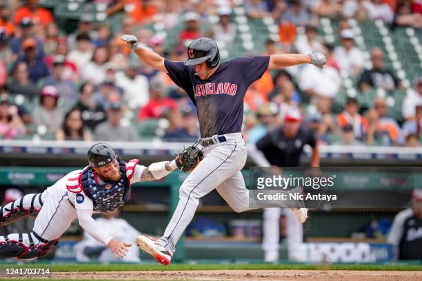 Myles Straw of the Cleveland Guardians is out at home on the throw, Robbie Grossman of the Detroit Tigers to Tucker Barnhart of the Detroit Tigers,...