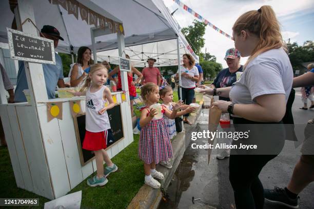 Children run a lemonade stand during the annual Independence Day Parade on July 4, 2022 in Southport, North Carolina. The U.S. Declaration of...