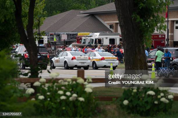 Law enforcement officers gather at the scene of the Fourth of July parade shooting in Highland Park, Illinois on July 4, 2022. - A shooter opened...