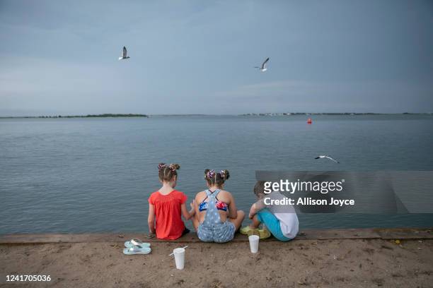 Children eat on a seawall after the annual Independence Day Parade on July 4, 2022 in Southport, North Carolina. The U.S. Declaration of Independence...