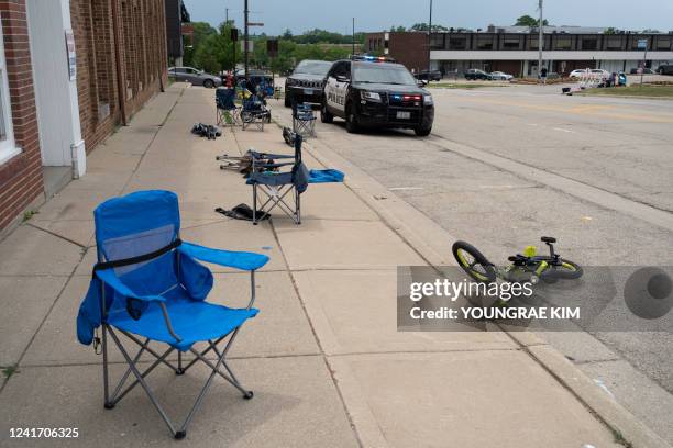 Toys and lawn chairs lay along the scene of the Fourth of July parade shooting in Highland Park, Illinois on July 4, 2022. - A shooter opened fire...