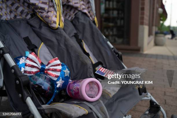 Baby stroller stand at the scene of the Fourth of July parade shooting in Highland Park, Illinois on July 4, 2022. - A shooter opened fire Monday...