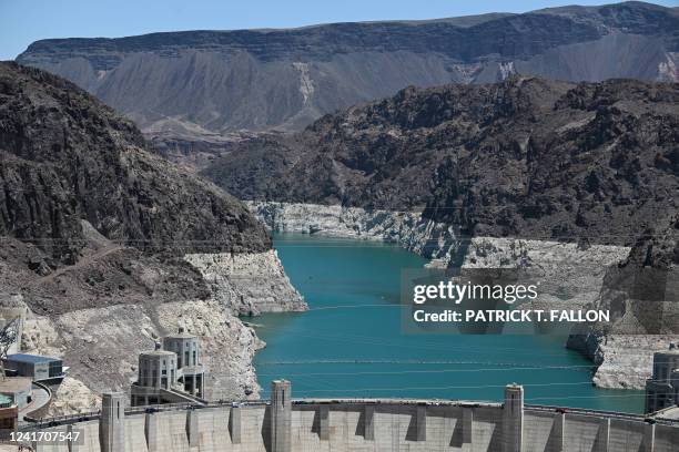 An aerial view shows the "bathtub ring", a white band of mineral deposits showing previous water levels, of Lake Mead on June 28, 2022 at the Hoover...