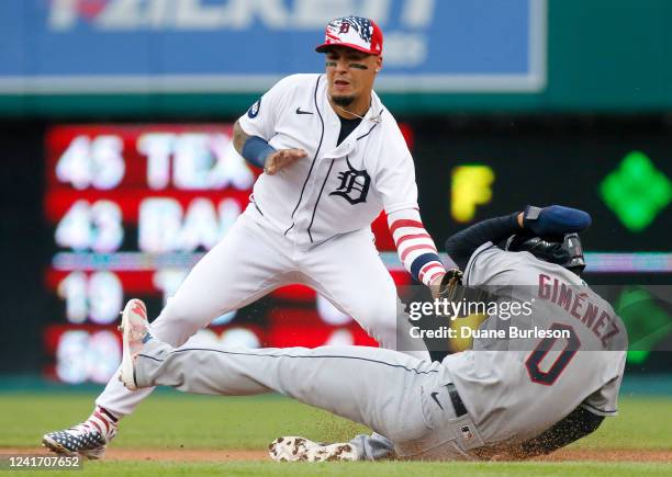 Shortstop Javier Baez of the Detroit Tigers tags out Andres Gimenez of the Cleveland Guardians trying to steal second base in the second inning of...