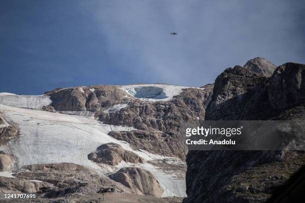 Fire brigade helicopter patrols the Marmolada massif in Trentino Alto Adige, on July 4, 2022. At least six people were killed after a large chunk of...