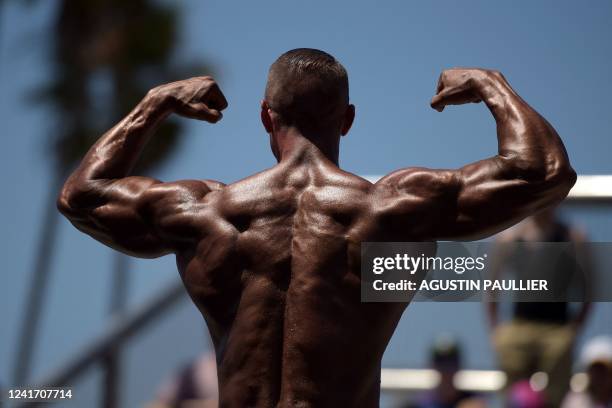Contestant participates in the Mr. & Ms. Muscle Beach championship on Independence Day in Venice, California on July 4, 2022. - Venice is one of two...