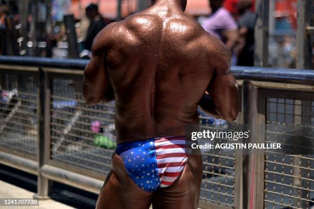 Contestant warms up during the Mr. & Ms. Muscle Beach championship on Independence Day in Venice, California on July 4, 2022. - Venice is one of two...