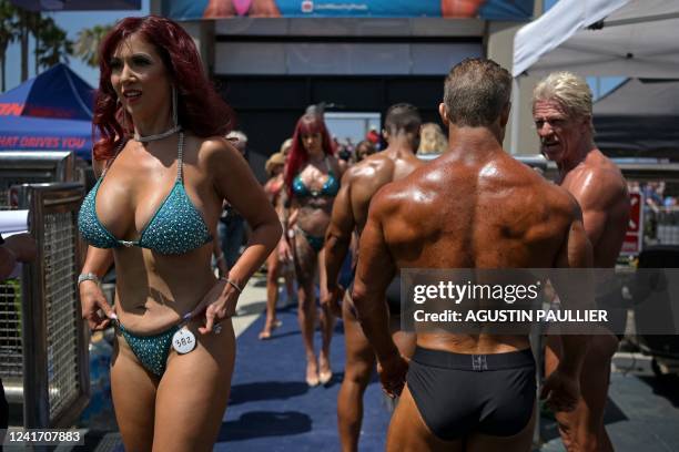 Contestants line up before competing in the Mr. & Ms. Muscle Beach championship on Independence Day in Venice, California on July 4, 2022. - Venice...