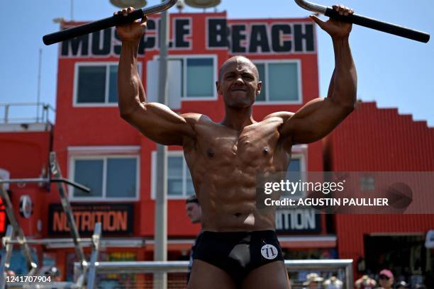 Contestant warms up during the Mr. & Ms. Muscle Beach championship on Independence Day in Venice, California on July 4, 2022. - Venice is one of two...