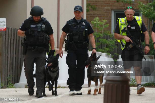 Law enforcement search the area of a shooting at a Fourth of July parade on July 4, 2022 in Highland Park, Illinois. Police have detained Robert...