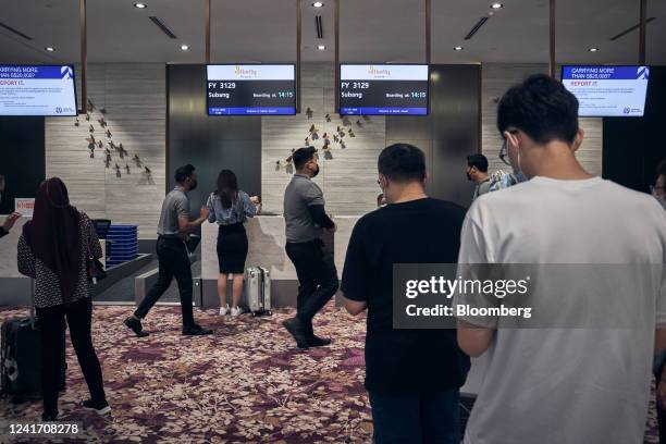 Passengers check in at the departure hall at Seletar Airport in Singapore, on Monday, June 13, 2022. Singapore has already signed two agreements with...