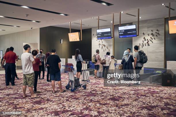 Passengers check in at the departure hall at Seletar Airport in Singapore, on Monday, June 13, 2022. Singapore has already signed two agreements with...