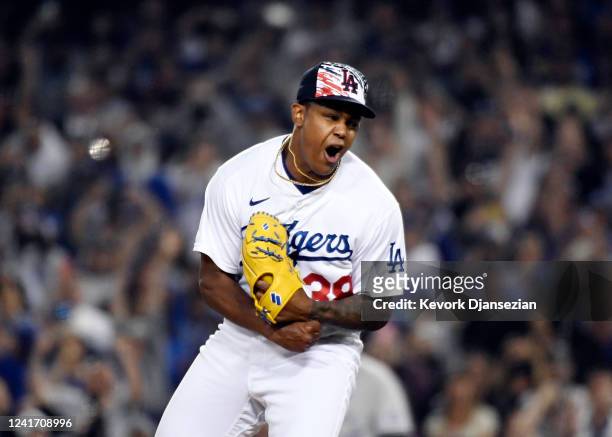 Relief pitcher Yency Almonte of the Los Angeles Dodgers reacts after striking out Connor Joe of the Colorado Rockies to earn the save in a 5-3 win...