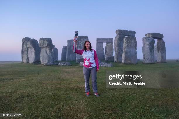 Sally Orange carries the Queen's Baton as The Queens Baton visits Stonehenge on July 5th, 2022 in England as part of the Birmingham 2022 Queens Baton...