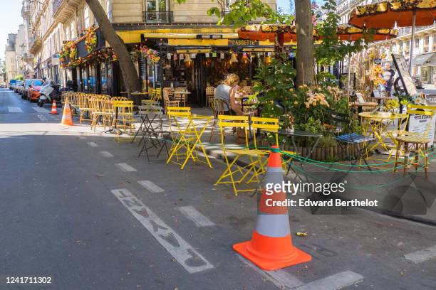 Extra space is created as people sit at the terrace of "Cafe Cassette", as bars and restaurants reopen after two months of nationwide restrictions...