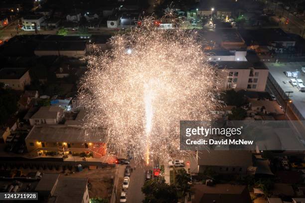 In an aerial view, large illegal fireworks are set off late into the night, long after the professional Independence Day shows have ended, on July 4,...