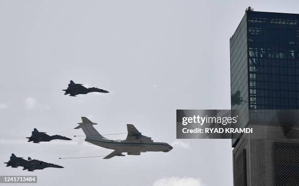 Algerian air force Sukhoi Su-30 fighter aircraft fly in formation alongside an Ilyushin IL-78 aerial refueling tanker over the capital Algiers on...