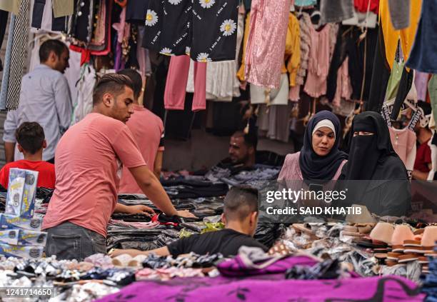 Palestinians shop at a market in Khan Yunis, in the southern Gaza Strip on July 5 as Muslims prepare for the Eid al-Adha festival and holiday.