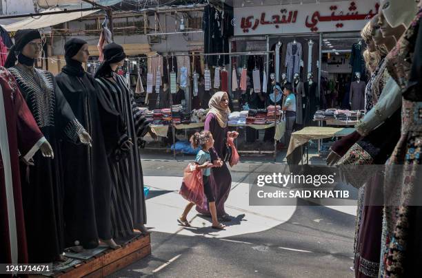 Palestinians shop at a market in Khan Yunis, in the southern Gaza Strip on July 5 as Muslims prepare for the Eid al-Adha festival and holiday.