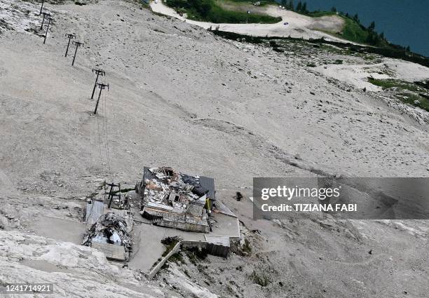 This aerial view taken near Canazei on July 5, 2022 from a rescue helicopter shows a destroyed refuge near the Punta Rocca glacier that collapsed on...