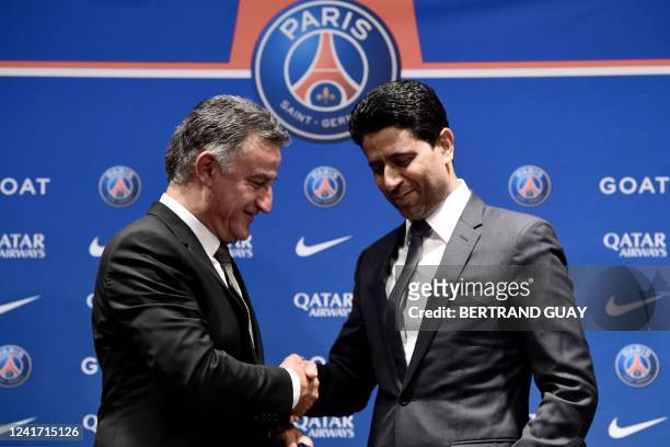 French coach Christophe Galtier and PSG's President Nasser Al-Khelaifi shake hands at the end of a press conference after Galtier was appointed as...
