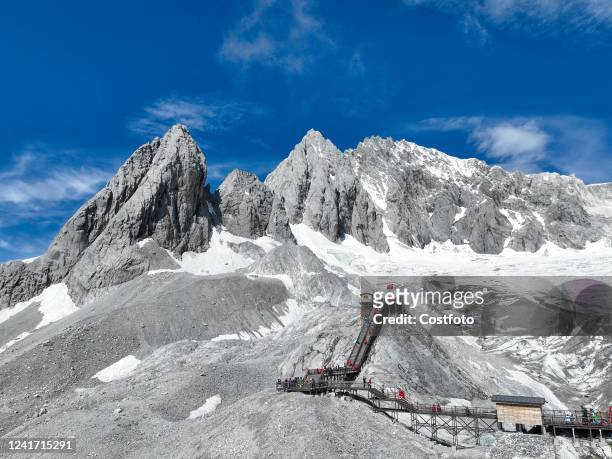 Aerial photo taken on July 5, 2022 shows tourists at the highest point of the Yulong Snow Mountain scenic area in Lijiang, Yunnan Province, China.