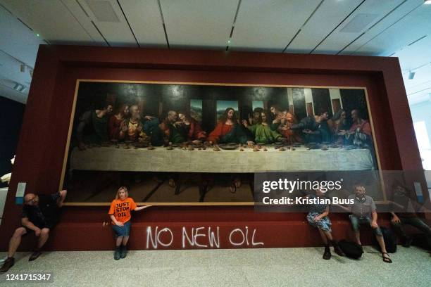 Five Just Stop Oil activists spray paint the wall and glue themselves to the frame of the painting the Last Supper on the 5th of July 2022, Royal...