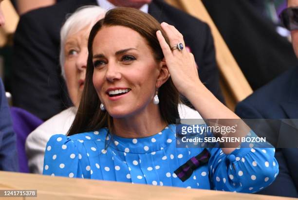 Britain's Catherine, Duchess of Cambridge reacts as she sits in the Royal Box at the Centre court prior to the start of the men's singles quarter...