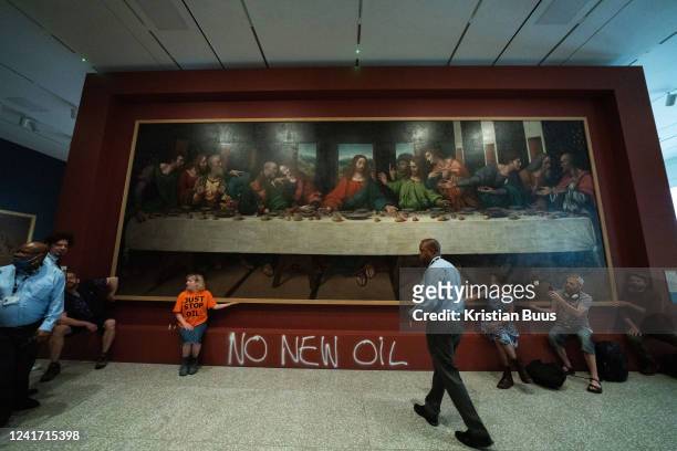 Five Just Stop Oil activists spray paint the wall and glue themselves to the frame of the painting the Last Supper on the 5th of July 2022, Royal...