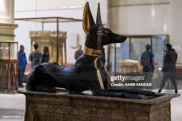 Visitors stand behind the Anubis shrine to view the other canopic shrines that were part of the burial collection of Tutankhamun , found in 1922 at...