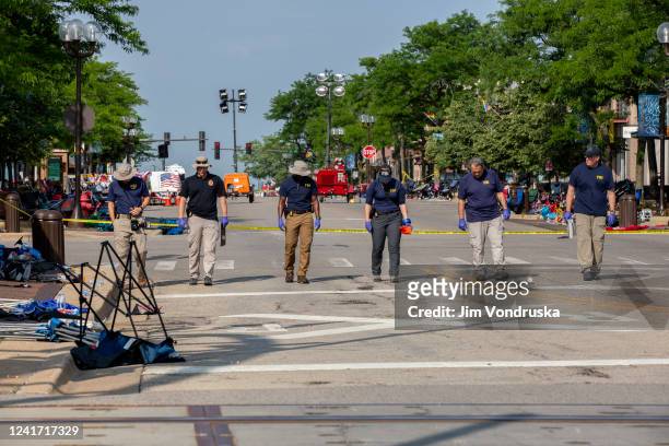 Agents work the scene of a shooting at a Fourth of July parade on July 5, 2022 in Highland Park, Illinois. Police have detained Robert “Bobby” E....