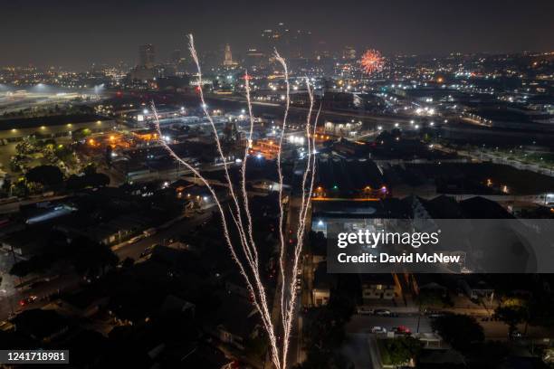 In an aerial view, large illegal fireworks are set off late into the night, long after the professional Independence Day shows have ended, on July 4,...