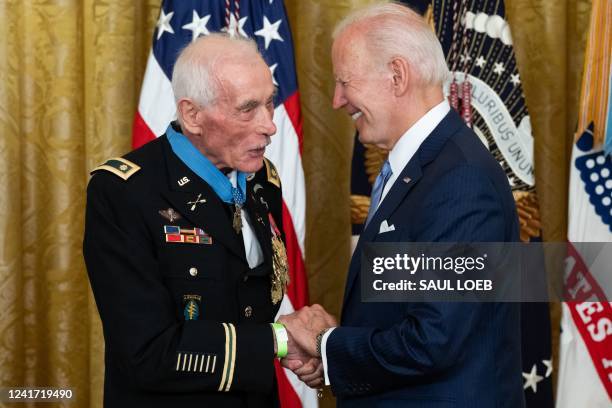 President Joe Biden shakes hands with retired US Army Major, John J. Duffy, after awarding him the Medal of Honor for his actions in the Vietnam War,...