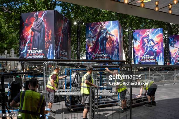 Work crew readies the red carpet area where billboards are already in place to adverstise the latest Marvel film 'Thor: Love and Thunder' whose...