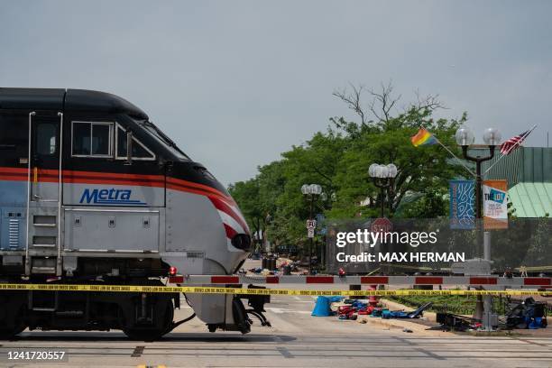 Metra commuter train passes through downtown Highland Park near the scene of a mass shooting at a July 4th Parade in downtown Highland Park, Illinois...