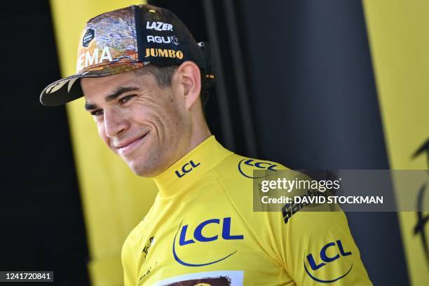 Belgian Wout Van Aert of Team Jumbo-Visma celebrates on the podium in the yellow jersey of leader in the overall ranking after stage four of the Tour...