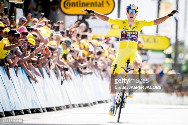 Belgian Wout Van Aert of Team Jumbo-Visma celebrates as he crosses the finish line of stage four of the Tour de France cycling race, a 171.5 km race...