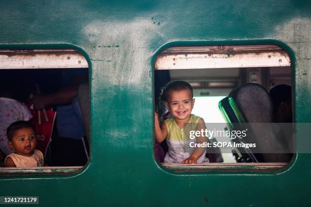 Children seen through the window of a train leaving for their hometowns for the upcoming festival Eid-al-Adha at the Kamalapur railway station.