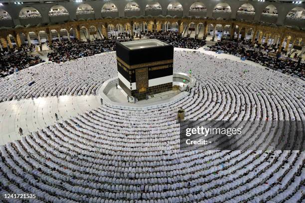 Muslim worshippers pray around the Kaaba at the Grand Mosque in Saudi Arabia's holy city of Mecca on July 5, 2022. One million people, including...