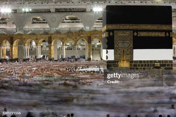 Muslim worshippers pray around the Kaaba at the Grand Mosque in Saudi Arabia's holy city of Mecca on July 5, 2022. One million people, including...