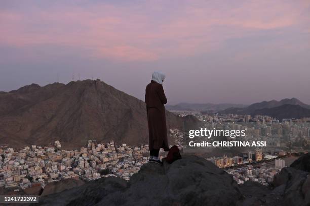 Muslim pilgrim looks over the holy city of Mecca from atop the Jabal al-Noor or 'Mountain of Light', on July 5, 2022. This year's hajj, the first...
