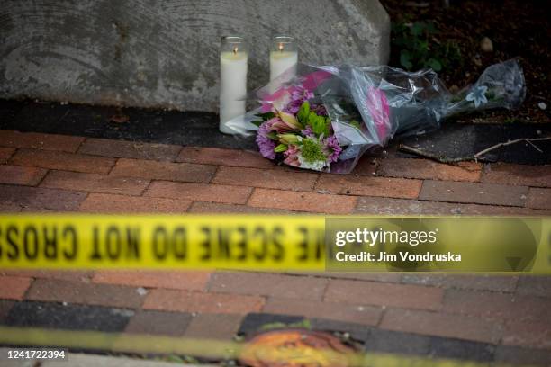 Flowers are laid near the scene of a shooting at a Fourth of July parade on July 5, 2022 in Highland Park, Illinois. Police have detained Robert...